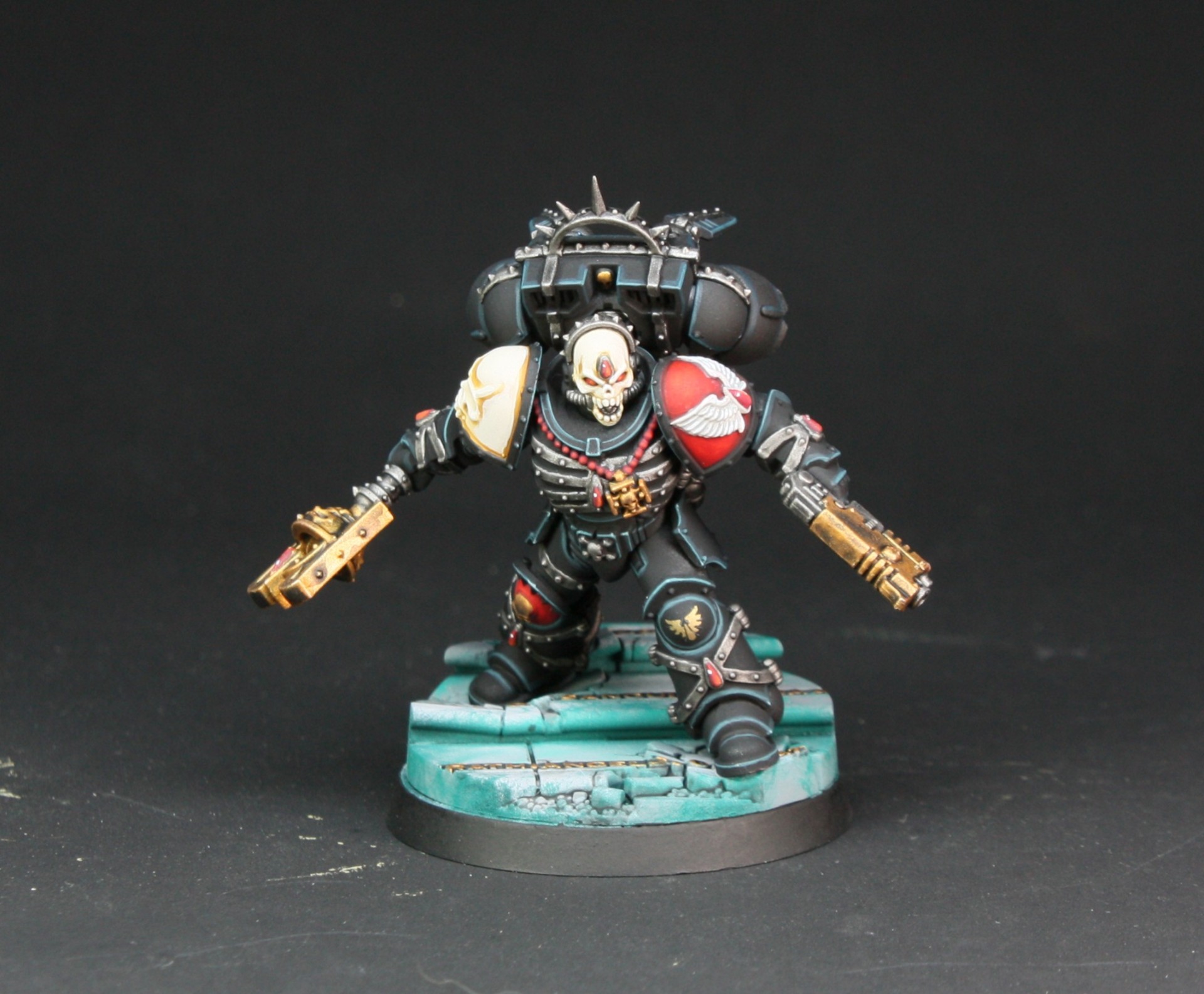 Blood Angels Chaplain in black armour with pistols drawn