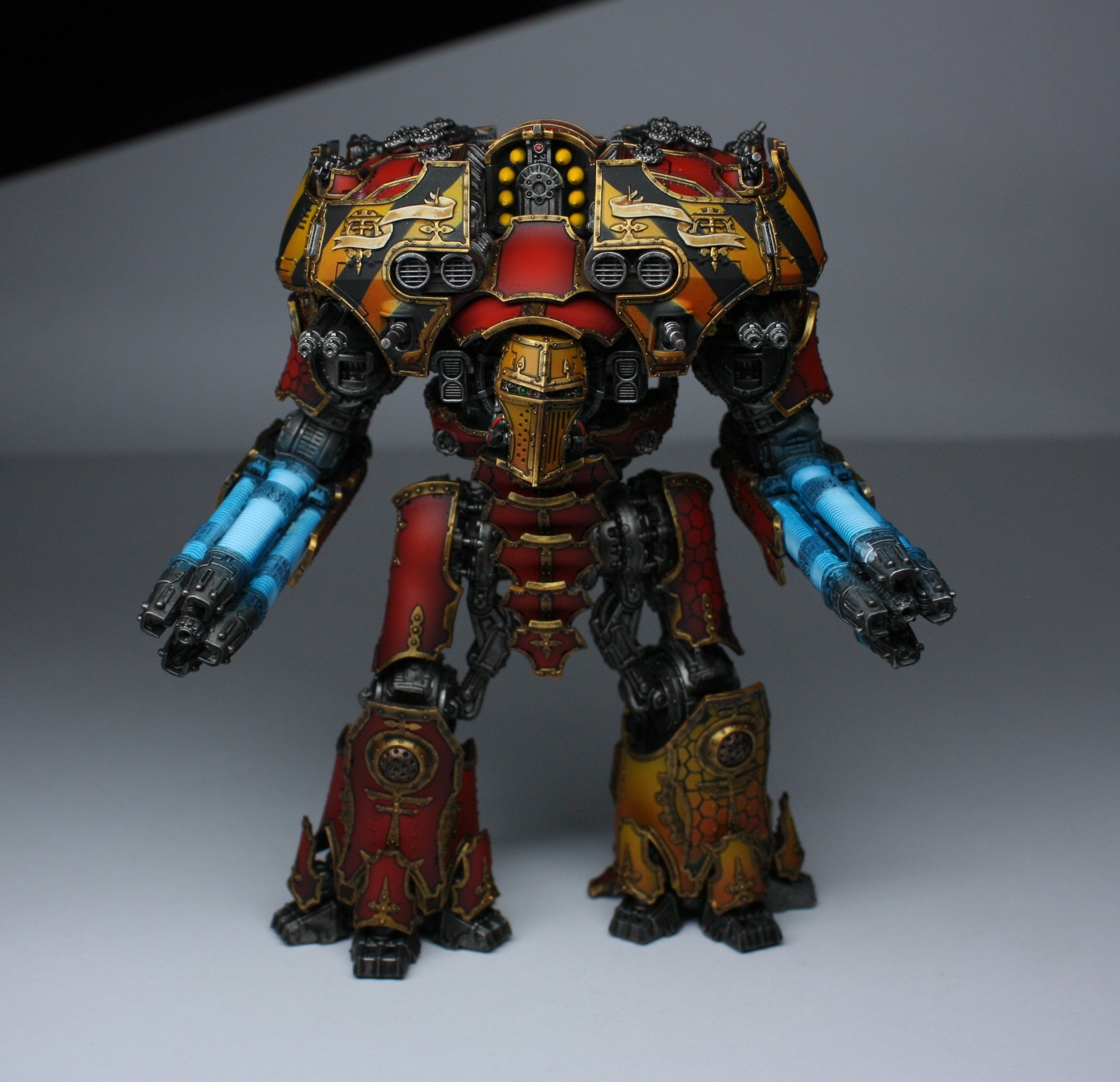 Red and gold Warlord Titan with twin gatling blasters and yellow hazard stripes