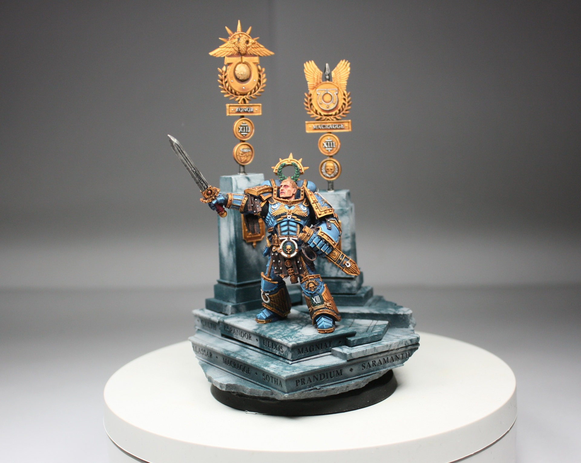 Roburte Guilliman display piece on marble plinth with Ultramarines banners