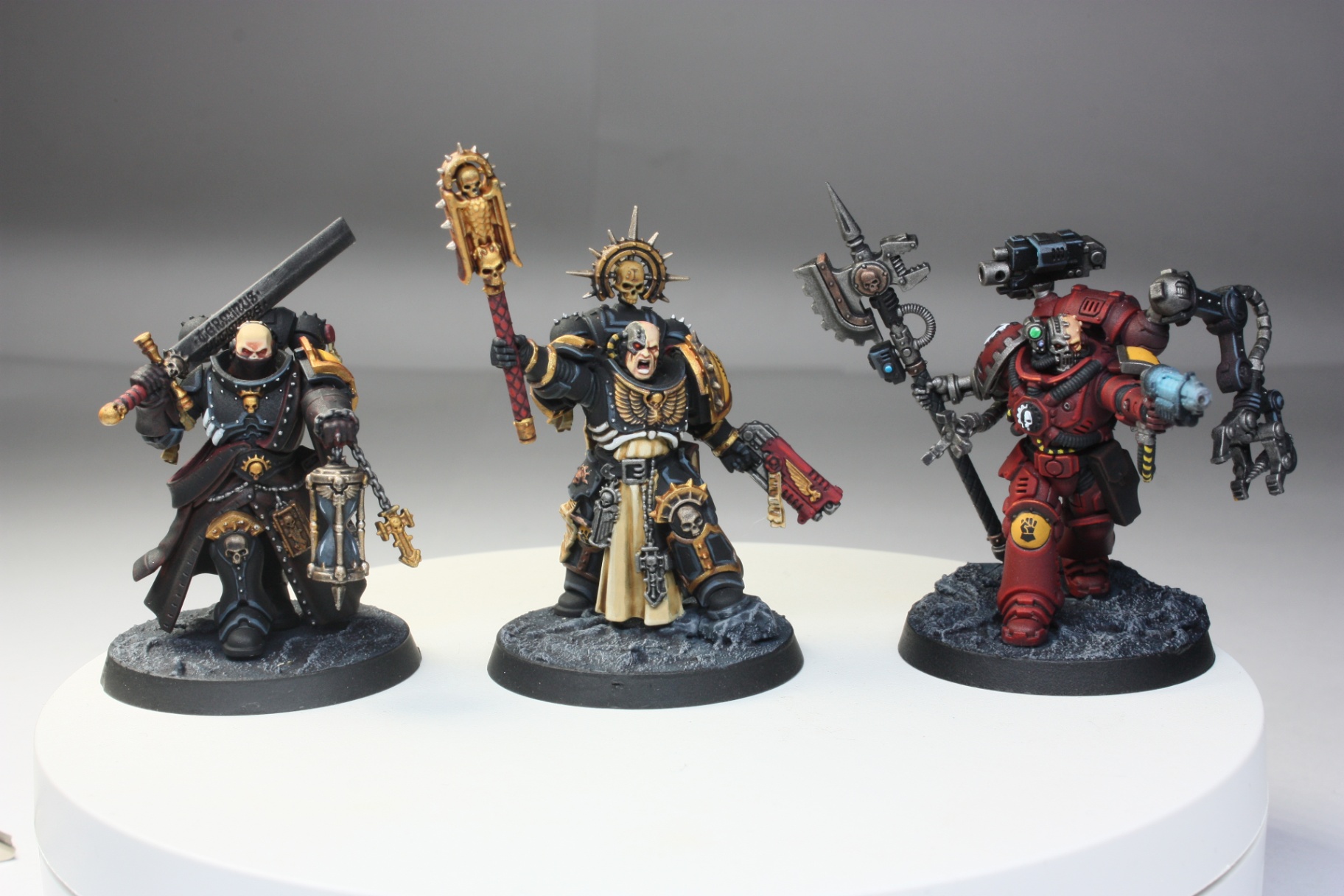 Space Marine character trio with chaplain, master of sanctity and red techmarine
