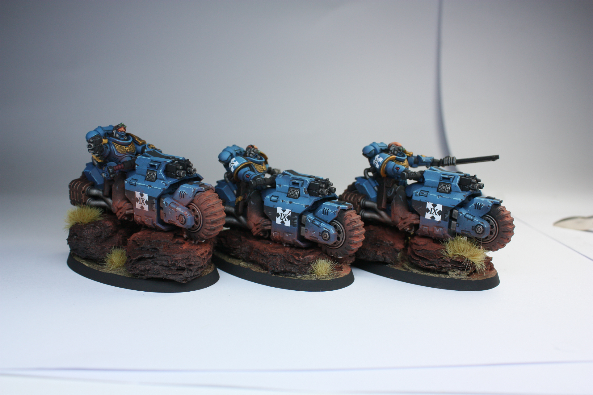Ultramarines Outriders trio on blue bikes with red rock bases