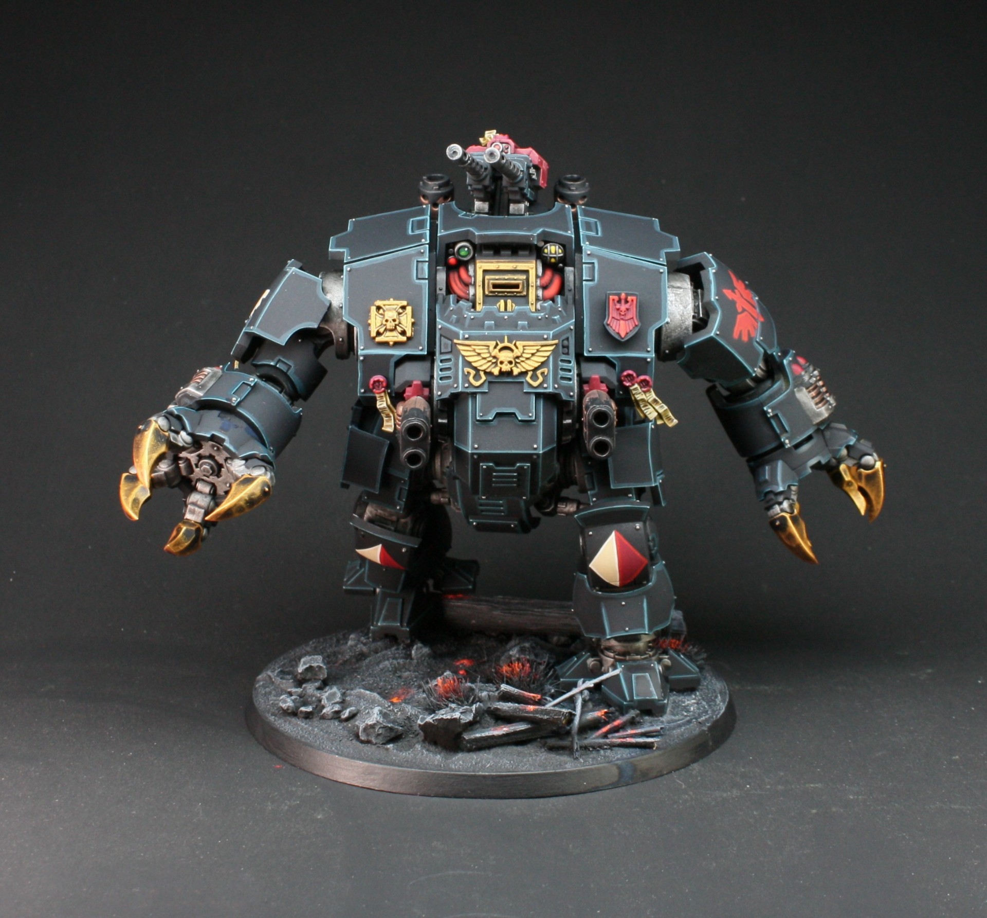 Dark Angels Redemptor Dreadnought in dark teal with golden claws on burning ruins