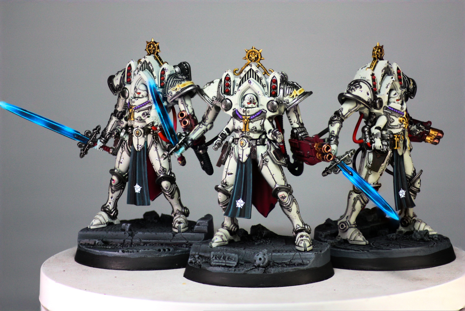 Adepta Sororitas Paragon Warsuits in bone armour with glowing blue blades