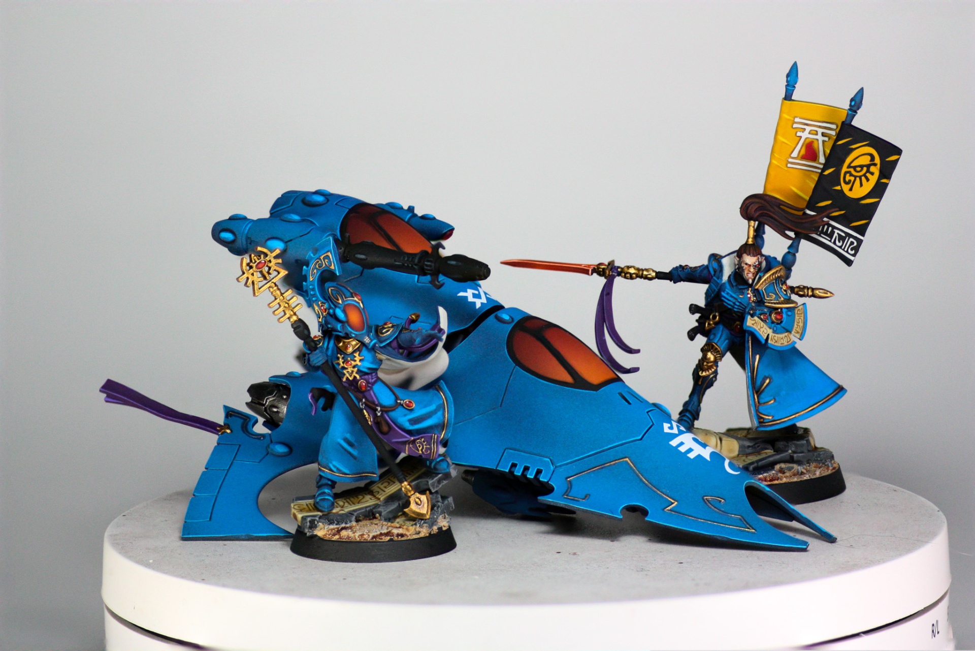 Aeldari Farseer and Autarch posed beside a blue grav-tank